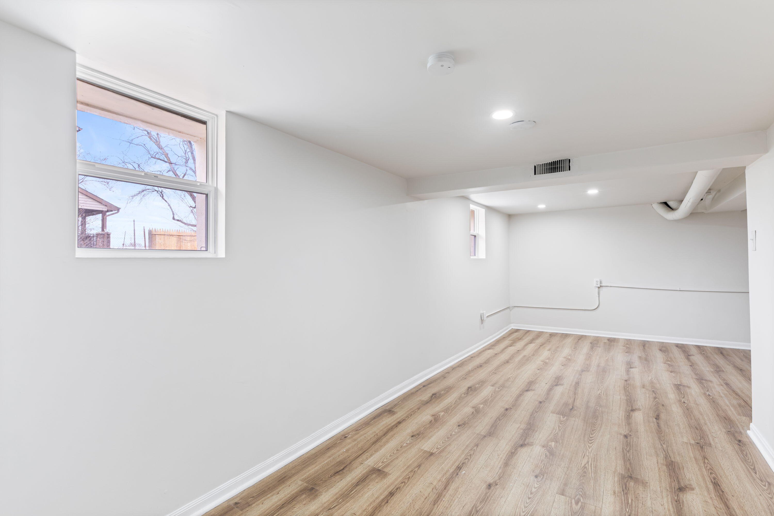560 Rhode Island Ct. Gary, IN 46402 - Photo 24 of 49 a view of empty room with wooden floor and fan