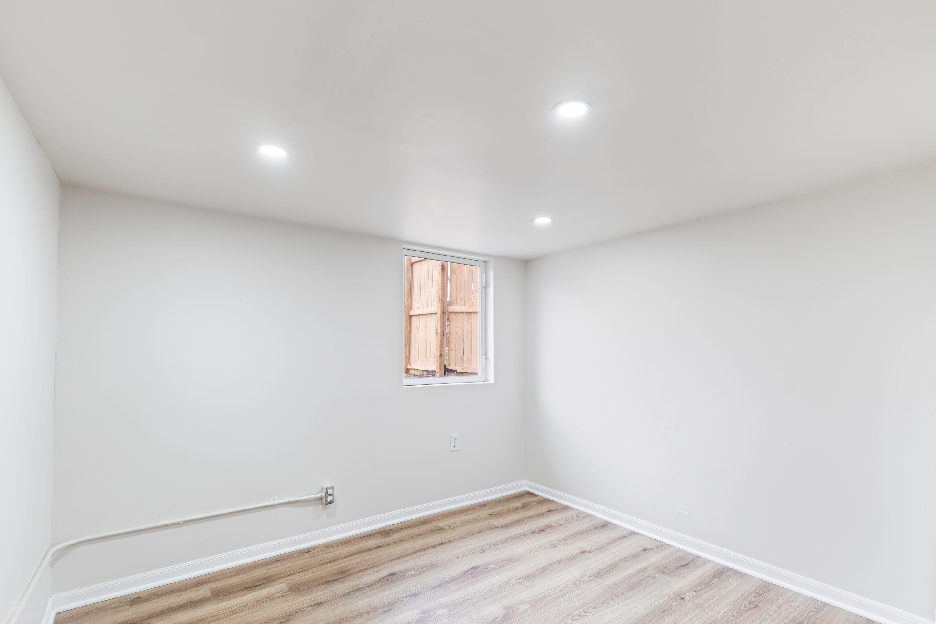 560 Rhode Island Ct. Gary, IN 46402 - Photo 44 of 49 an empty room with wooden floor and windows