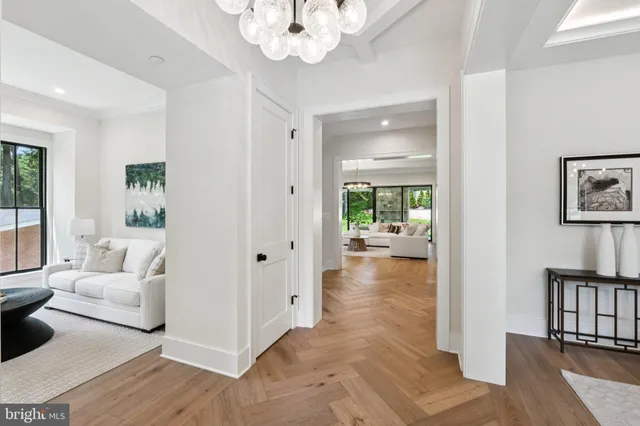 a view of a livingroom with wooden floor and a chandelier