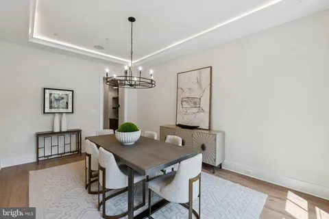 a view of a dining room with furniture and chandelier