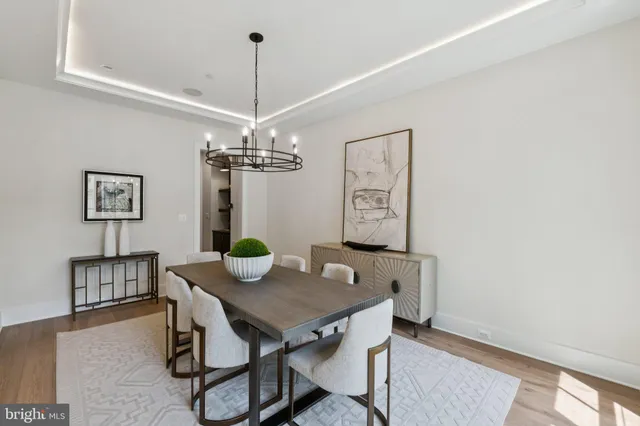 a view of a dining room with furniture and chandelier