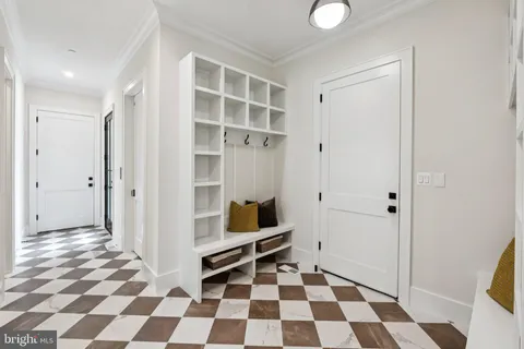 a view of a big room with wooden floor and windows