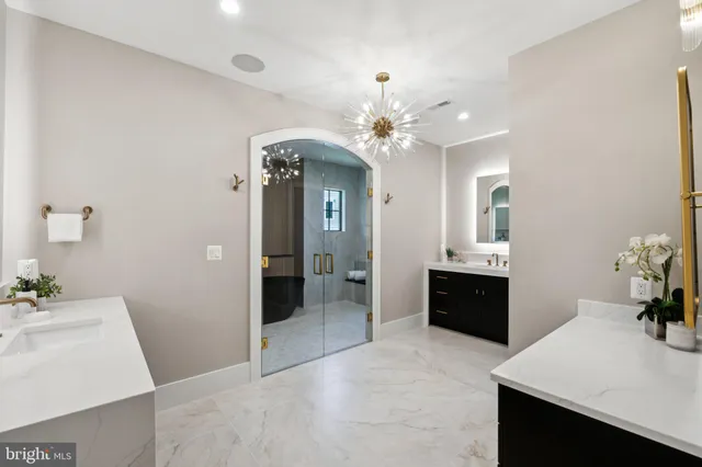 a spacious bathroom with a sink double vanity granite and a shower