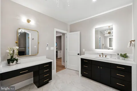 a spacious bathroom with a double vanity sink and mirror