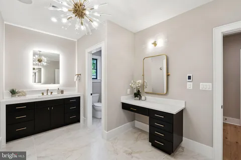 a spacious bathroom with a sink vanity and mirror