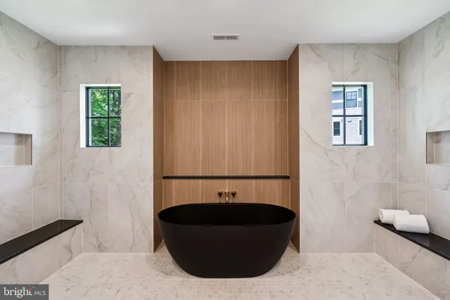 a spacious bathroom with a glass shower door and a sink