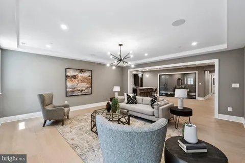 a living room with furniture and a chandelier