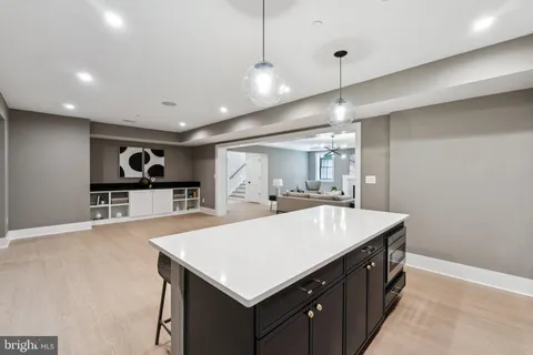 a kitchen with a stove a refrigerator and a sink