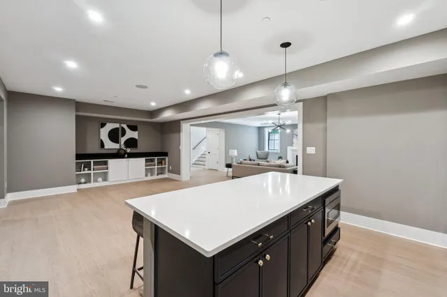 a kitchen with a stove a refrigerator and a sink