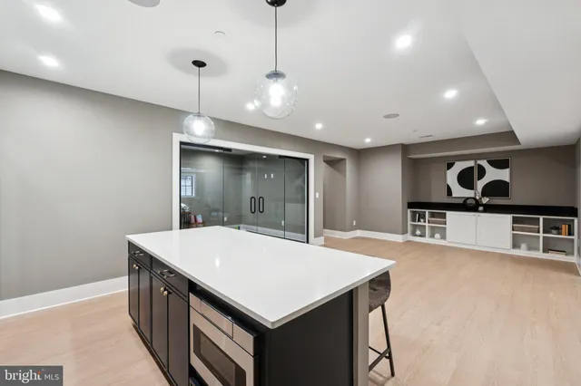 a kitchen with a kitchen island a sink dining table and chairs