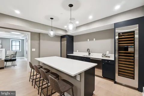 a room with furniture and view of kitchen