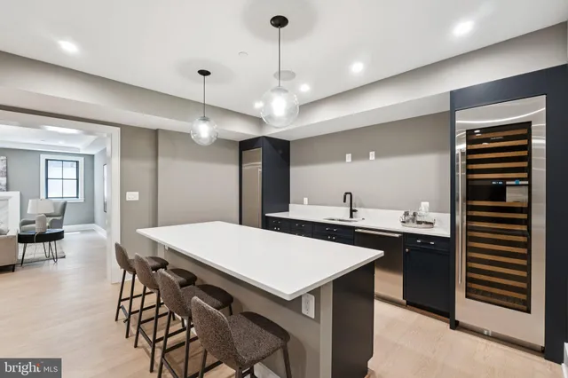 a room with furniture and view of kitchen