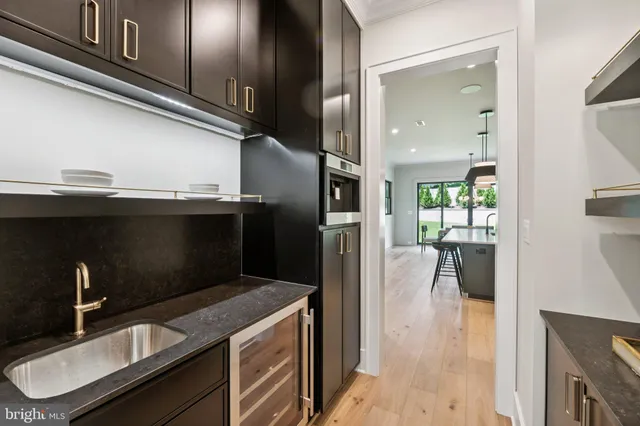a kitchen with a sink stainless steel appliances and cabinets