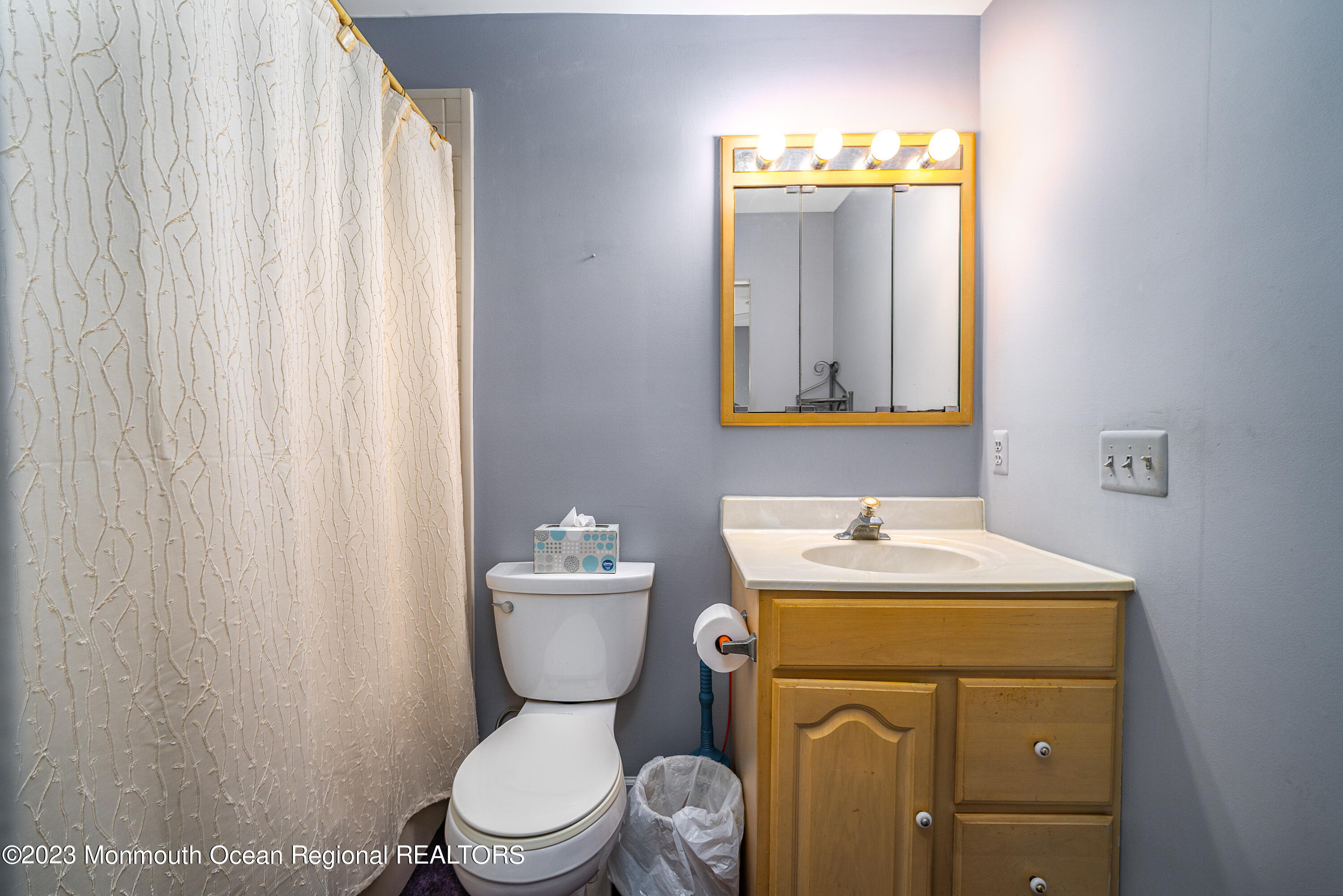 501 First Street Toms River, NJ 08757 - Photo 19 of 32 a bathroom with a toilet sink vanity and mirror