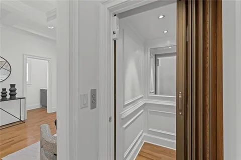 a view of a hallway with wooden floor and entryway
