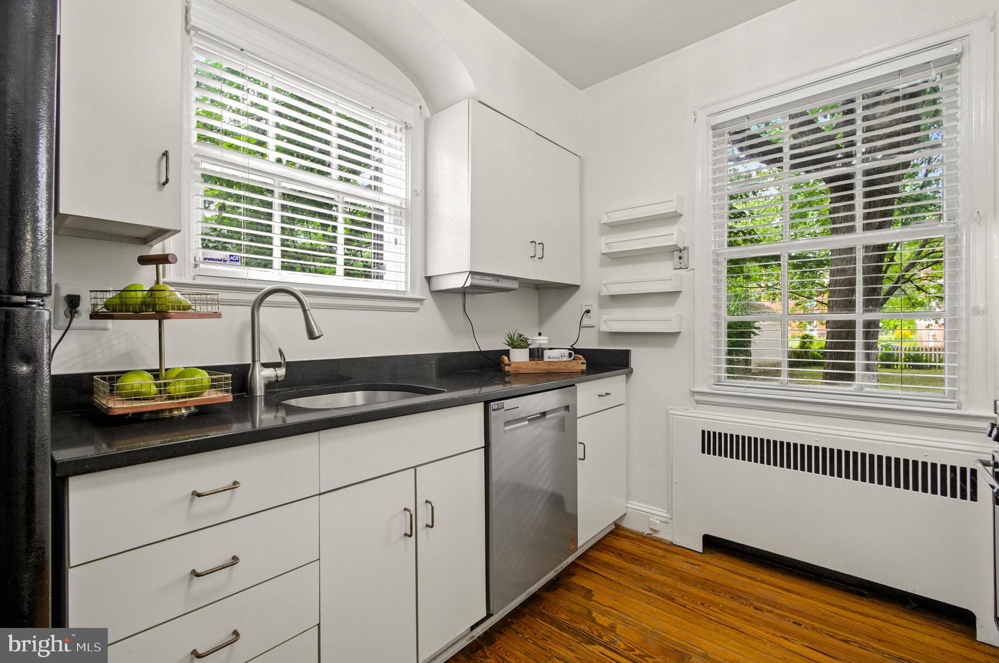 310 Paddington Road Baltimore, MD 21212 - Photo 13 of 59 a kitchen with granite countertop white cabinets and a window