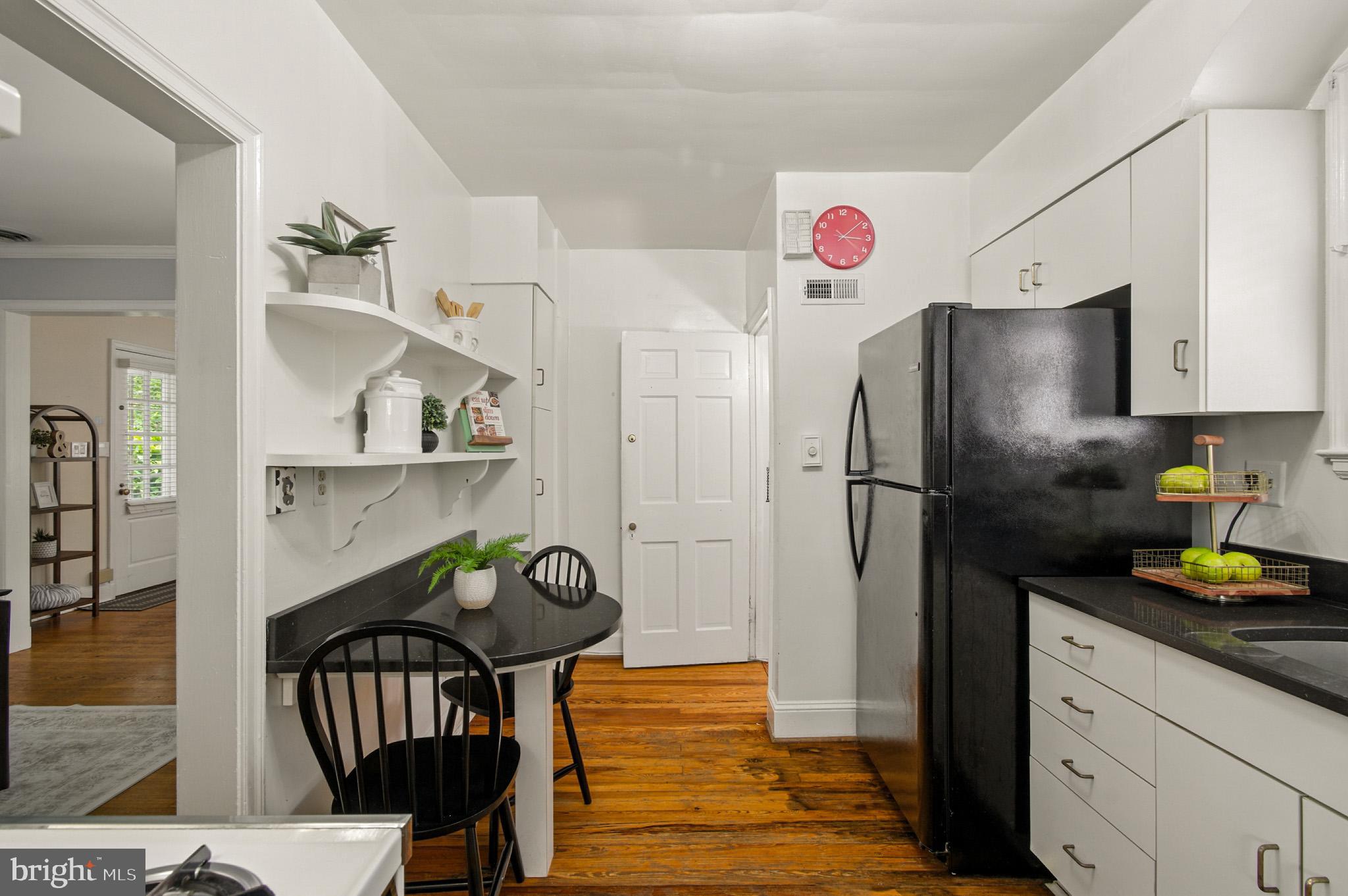 310 Paddington Road Baltimore, MD 21212 - Photo 15 of 59 a kitchen with stainless steel appliances a refrigerator a table and chairs in it