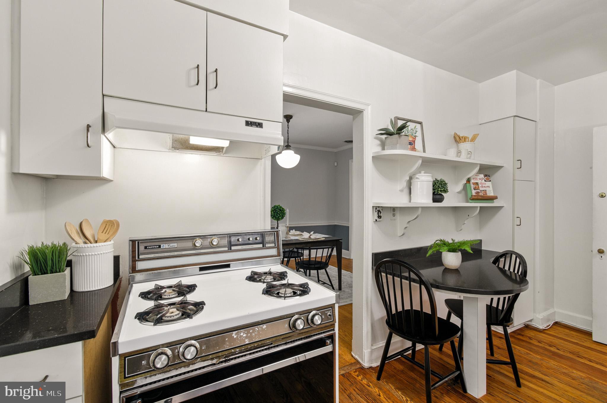 310 Paddington Road Baltimore, MD 21212 - Photo 16 of 59 a kitchen with a stove and white cabinets