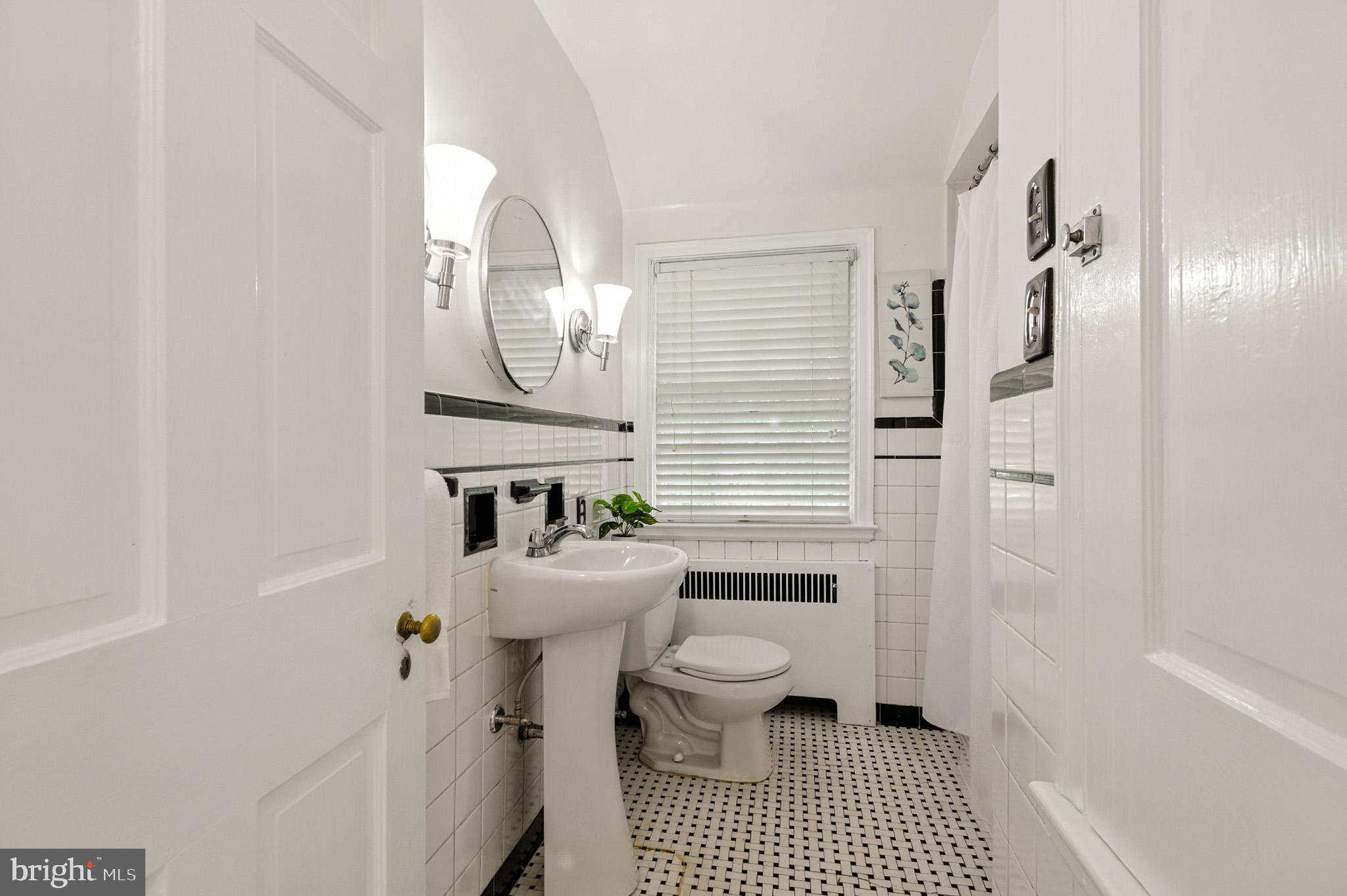 310 Paddington Road Baltimore, MD 21212 - Photo 22 of 59 a bathroom with a sink a toilet and shower