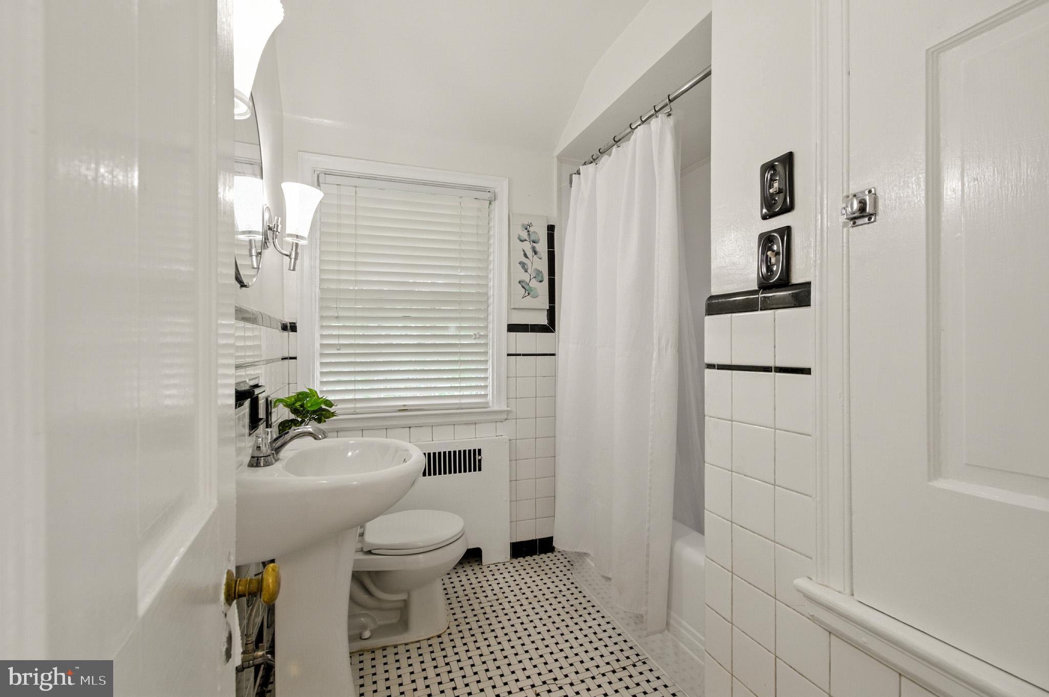 310 Paddington Road Baltimore, MD 21212 - Photo 23 of 59 a bathroom with a toilet a sink and shower