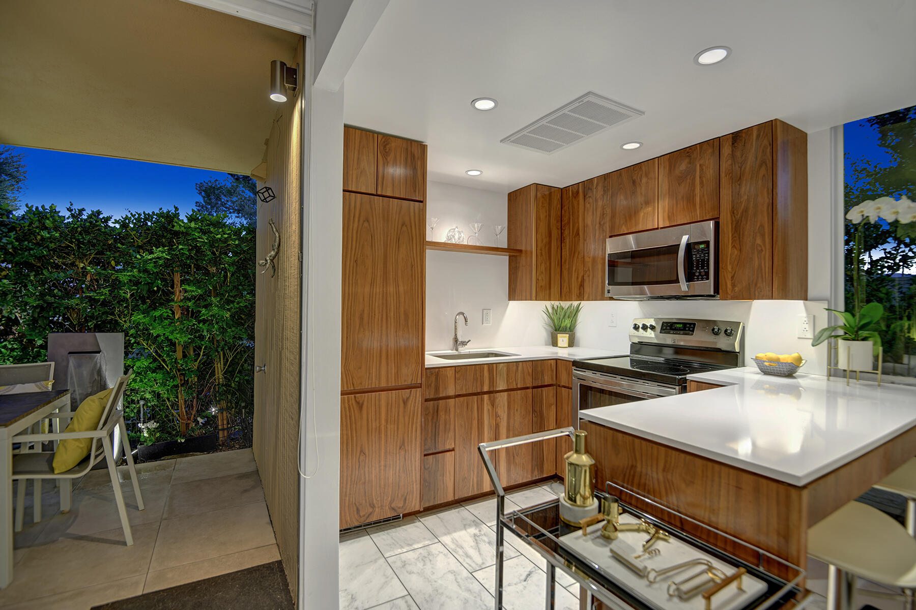 360 Cabrillo Road, Unit 202 Palm Springs, CA 92262 - Photo 44 of 49 KITCHEN TO BACK PATIO NIGHT MLS