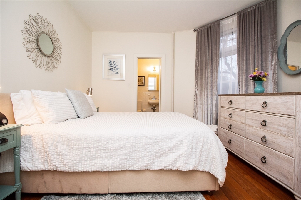 1871 Beacon Street, Unit 3 Brookline, MA 02445 - Photo 11 of 14 a bedroom with a bed and wooden floor