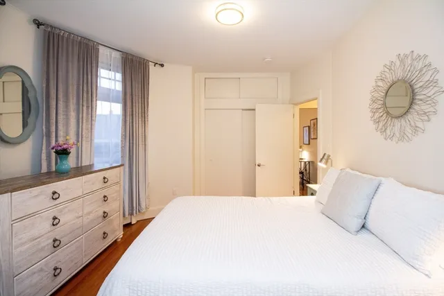 a bedroom with a large bed and a dresser