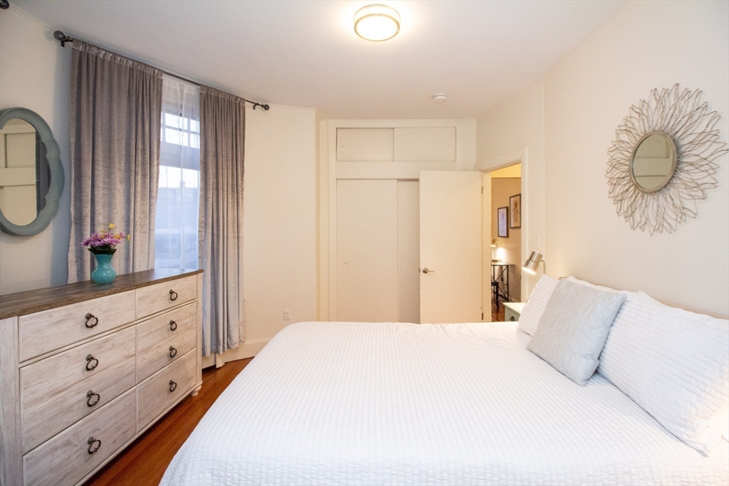 1871 Beacon Street, Unit 3 Brookline, MA 02445 - Photo 12 of 14 a bedroom with a large bed and a dresser