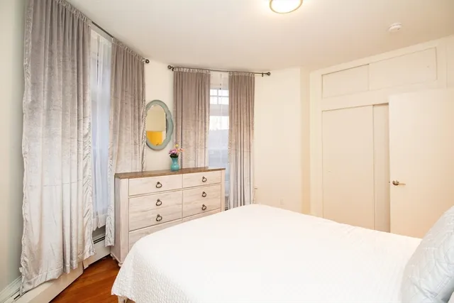 a bedroom with a bed and a dresser