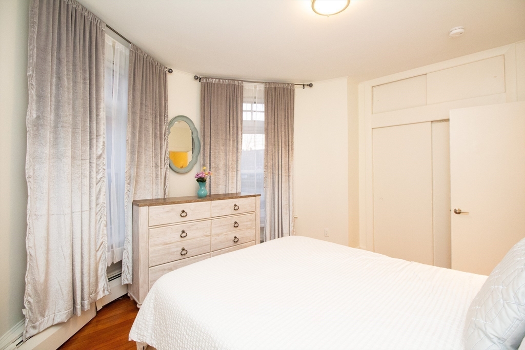 1871 Beacon Street, Unit 3 Brookline, MA 02445 - Photo 13 of 14 a bedroom with a bed and a dresser