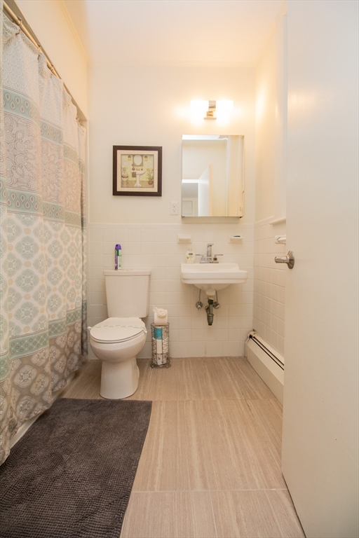 1871 Beacon Street, Unit 3 Brookline, MA 02445 - Photo 14 of 14 a bathroom with a toilet sink and mirror