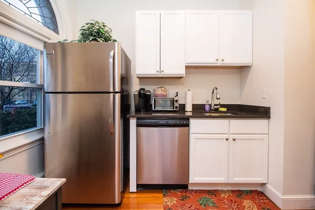 a white refrigerator freezer sitting inside of a kitchen