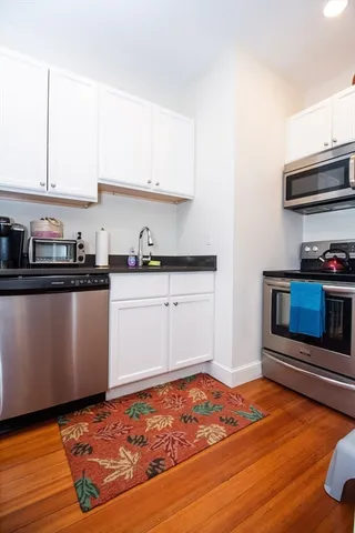 a kitchen with stainless steel appliances granite countertop a sink stove and microwave