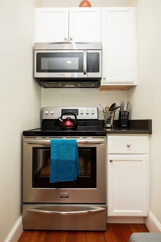 a kitchen with stainless steel appliances granite countertop a stove and a microwave