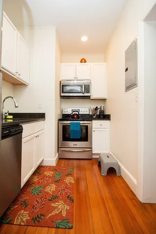 a kitchen with a sink appliances and cabinets