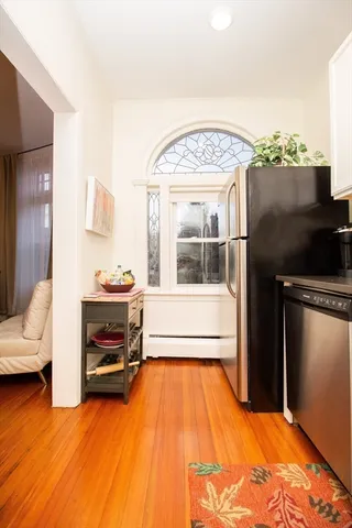 a view of living room and kitchen with furniture wooden floor and window