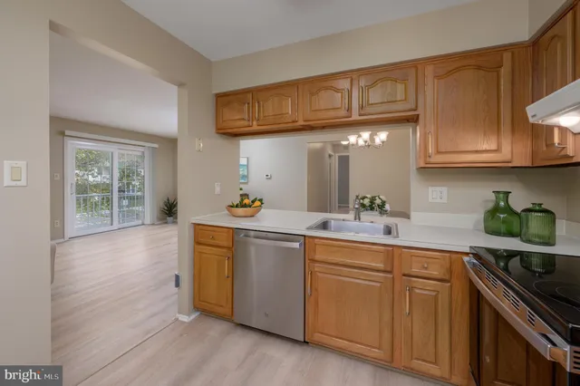 a kitchen with stainless steel appliances granite countertop a sink and cabinets