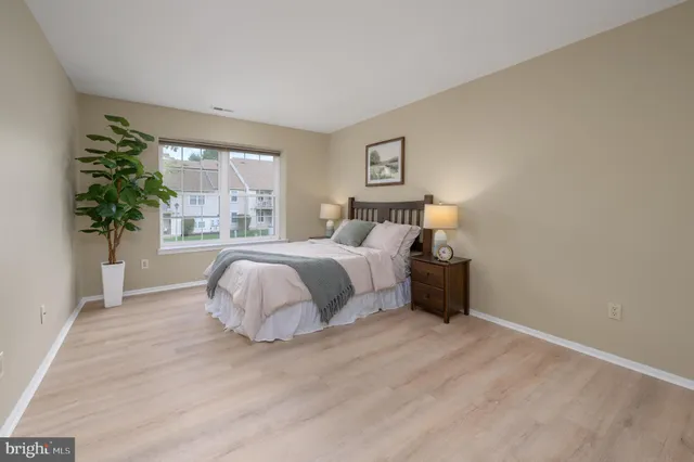 a bedroom with a bed potted plant and a window
