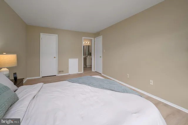 a bedroom with a bed and a lamp