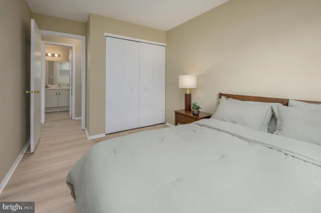 a bedroom with a bed and a night stand