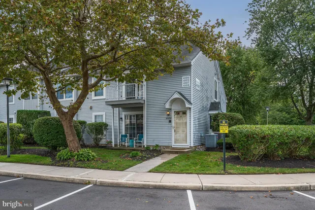 a front view of a house with a yard and a garage
