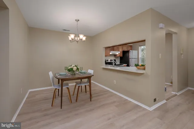 a workspace with wooden floor and a chandelier
