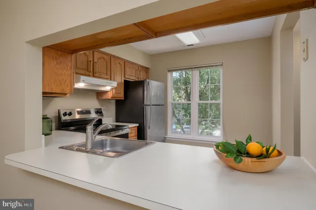a kitchen with a sink a stove and a window
