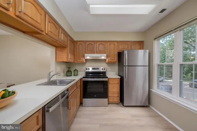 a kitchen with a sink a refrigerator and a stove