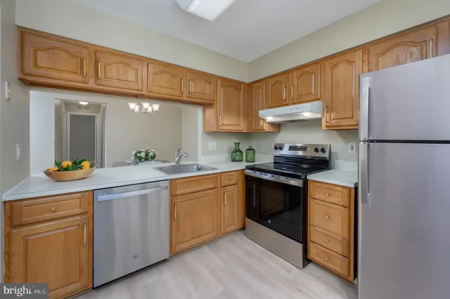 a kitchen with cabinets and stainless steel appliances