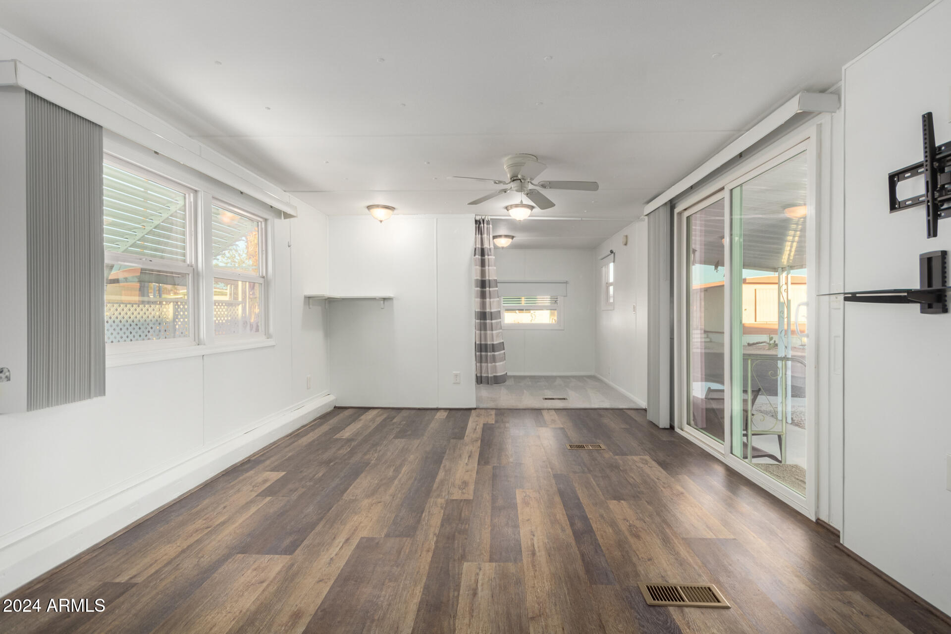 44 South Hawes Road, Unit A15 Mesa, AZ 85208 - Photo 13 of 40 an empty room with wooden floor and windows