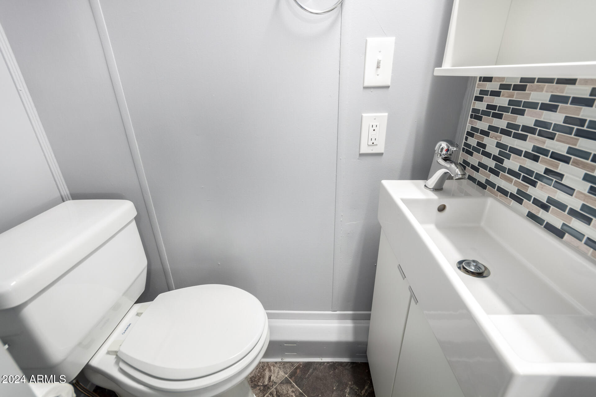 44 South Hawes Road, Unit A15 Mesa, AZ 85208 - Photo 23 of 40 a white toilet sitting next to a bathroom sink