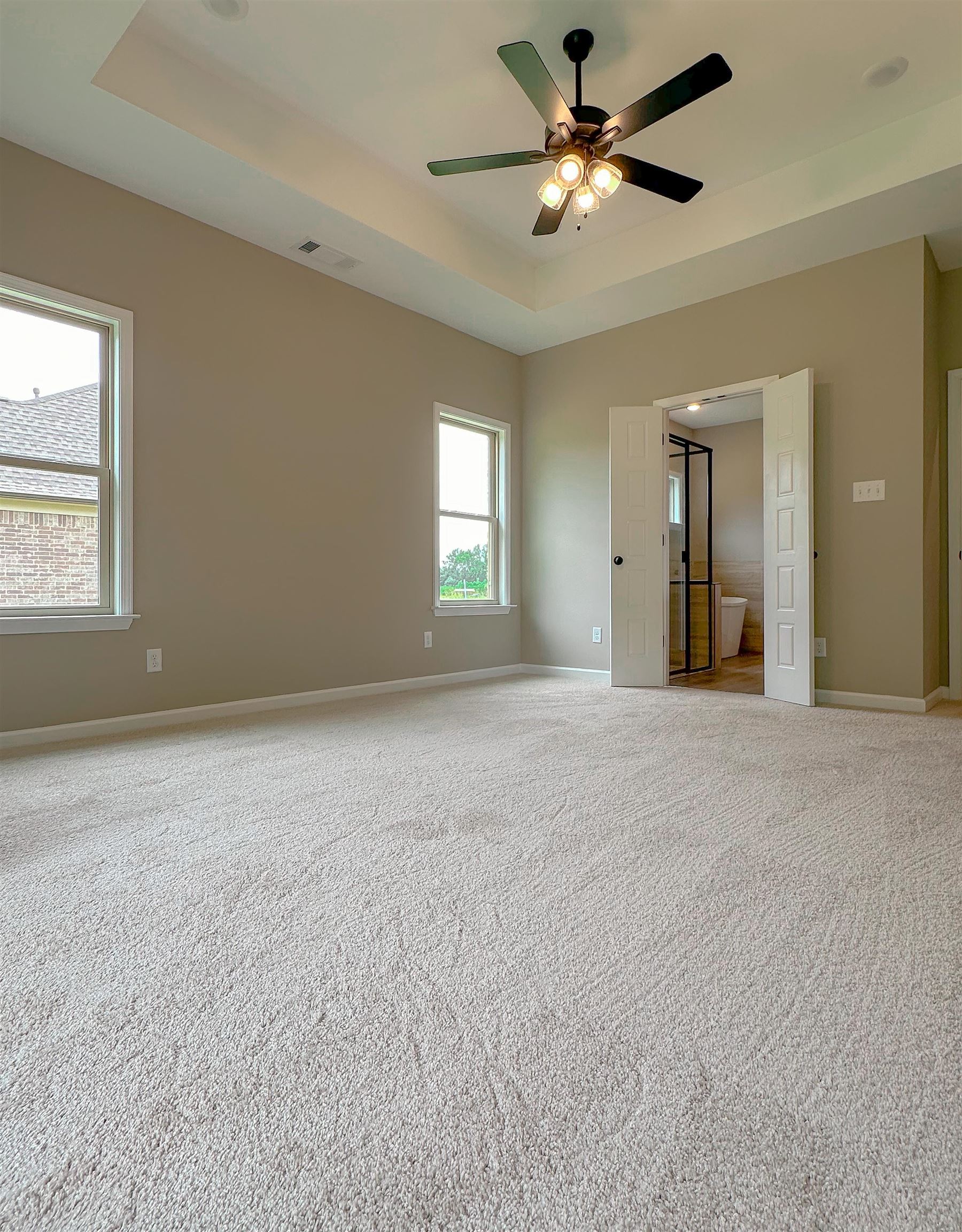126 Stewart Road Munford, TN 38058 - Photo 13 of 23 Empty room with a tray ceiling, ceiling fan, and carpet floors