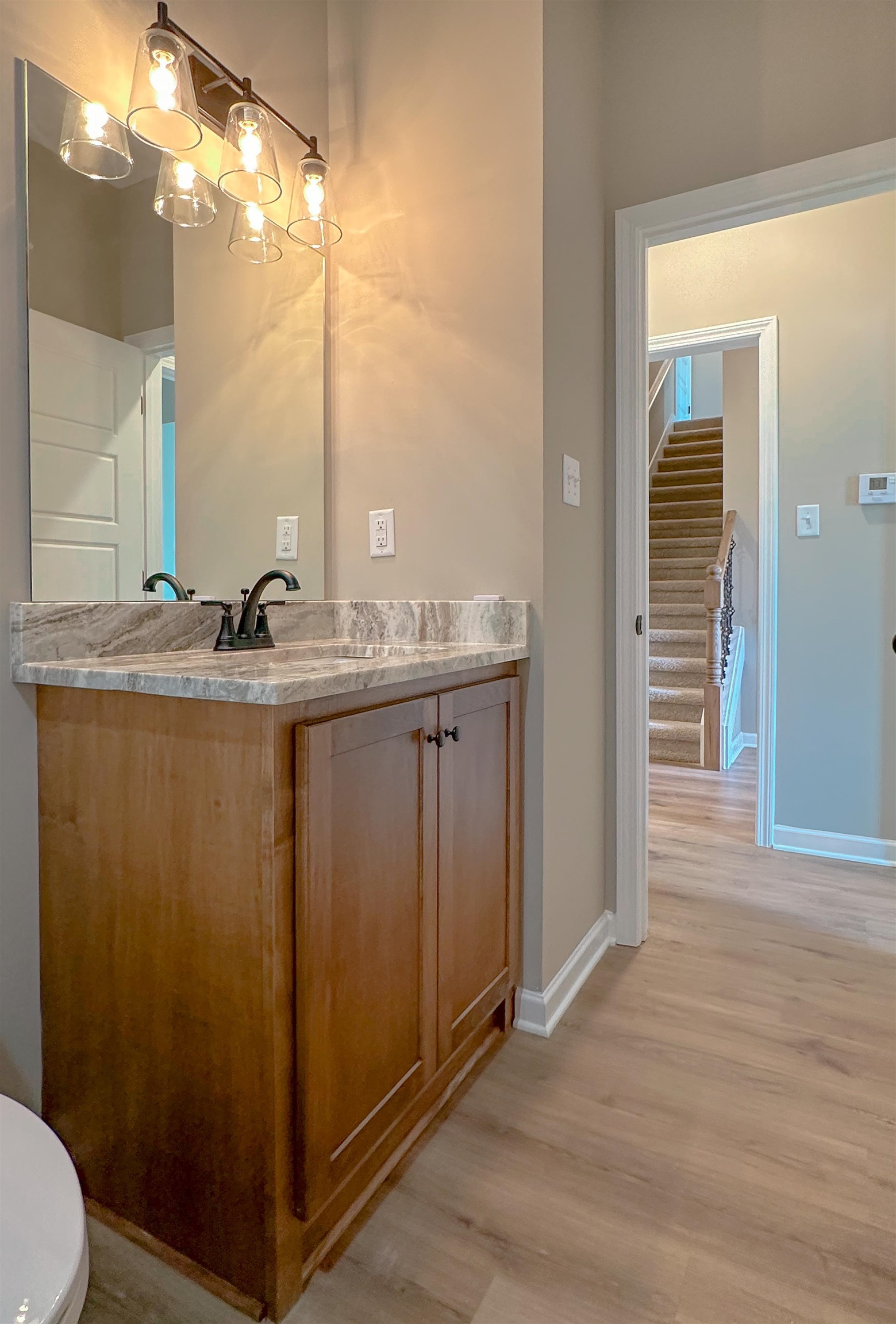126 Stewart Road Munford, TN 38058 - Photo 20 of 23 Bathroom with vanity, toilet, and wood-type flooring