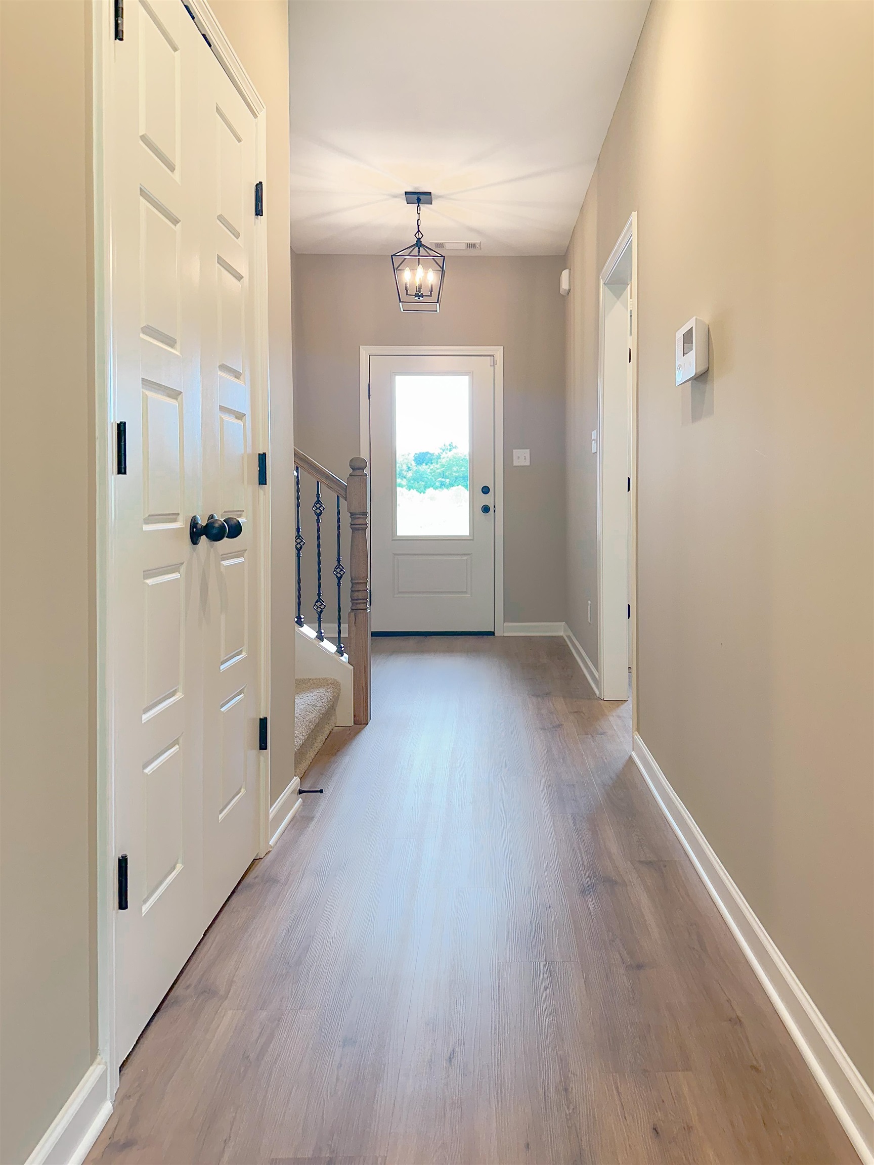 126 Stewart Road Munford, TN 38058 - Photo 2 of 23 Entryway featuring light wood-type flooring and an inviting chandelier